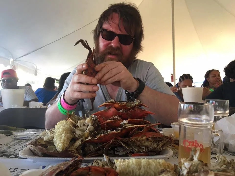 Charlie eating crabs at a table, the messy inspiration behind LazyTowel